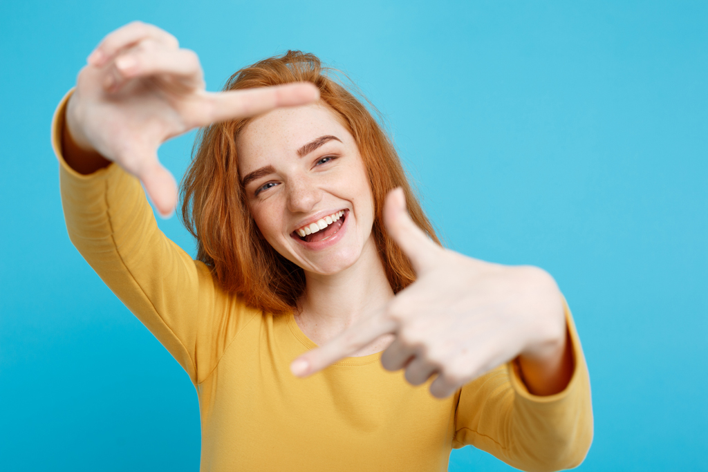 Close Up Portrait Young Beautiful Attractive Redhair Girl Smiling Looking At Camera On Blue Pastel Background