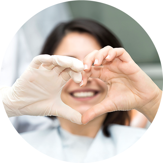 Dentist And Female Patient Making Heart Symbol With Their Hands Together