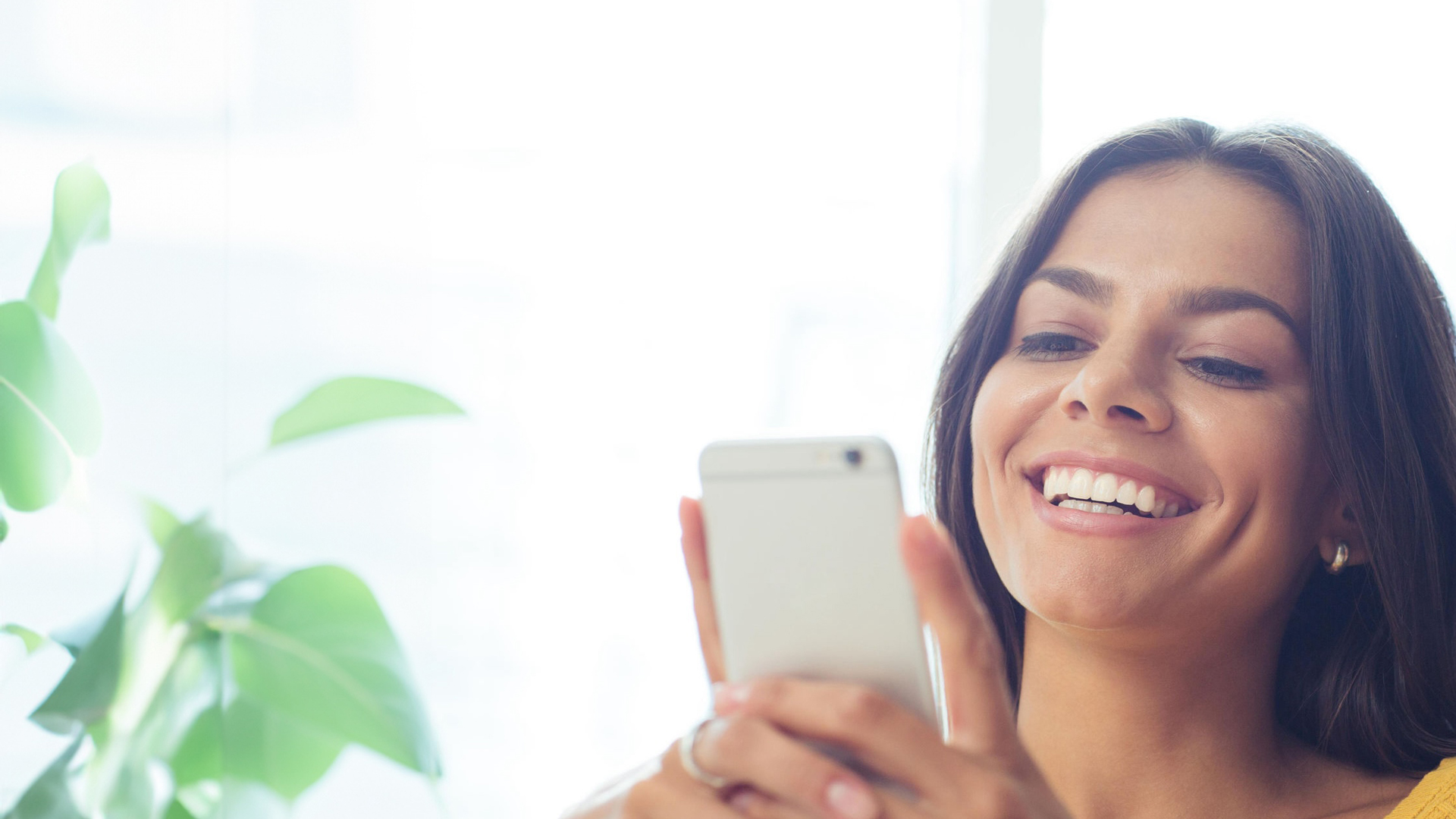 Woman Smiling Looking At Her Phone