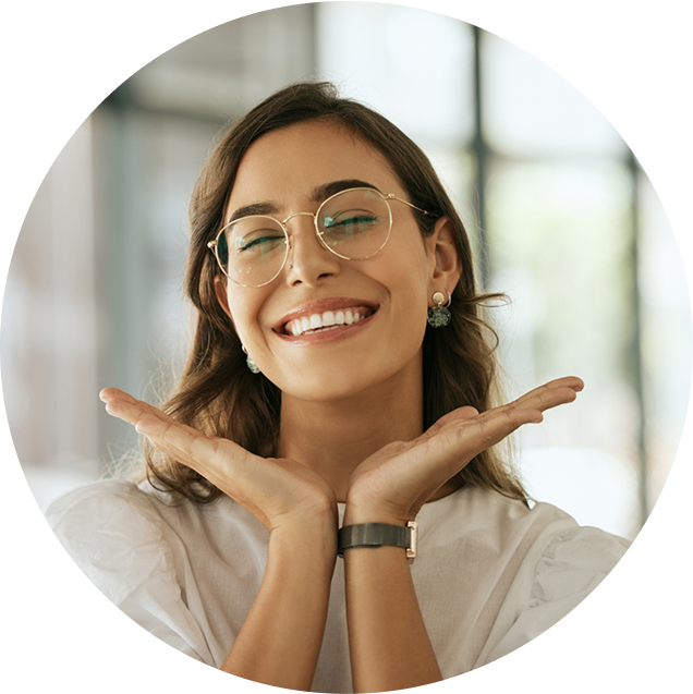 a tan woman with glasses showcasing her new smile
